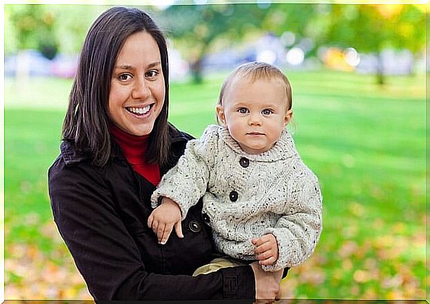 Woman with a child in her arms enjoys life