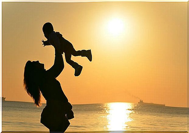 Woman lifts up child who is most important in her life